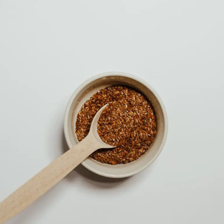 Mixing bowl with mashed banana, eggs, and dry ingredients for chia oatmeal cups