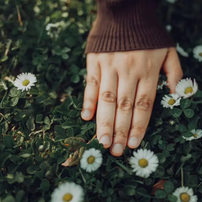 Person walking barefoot on grass practicing earthing for stress reduction