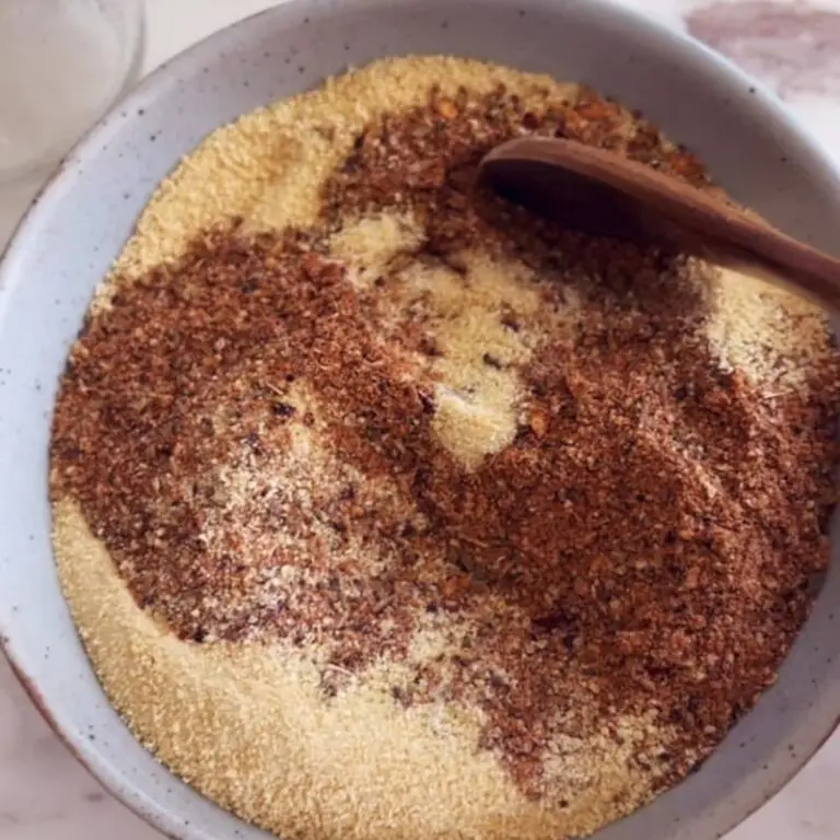 Organic spices for homemade BBQ rub including smoked paprika, maple sugar, garlic, and cinnamon on white surface