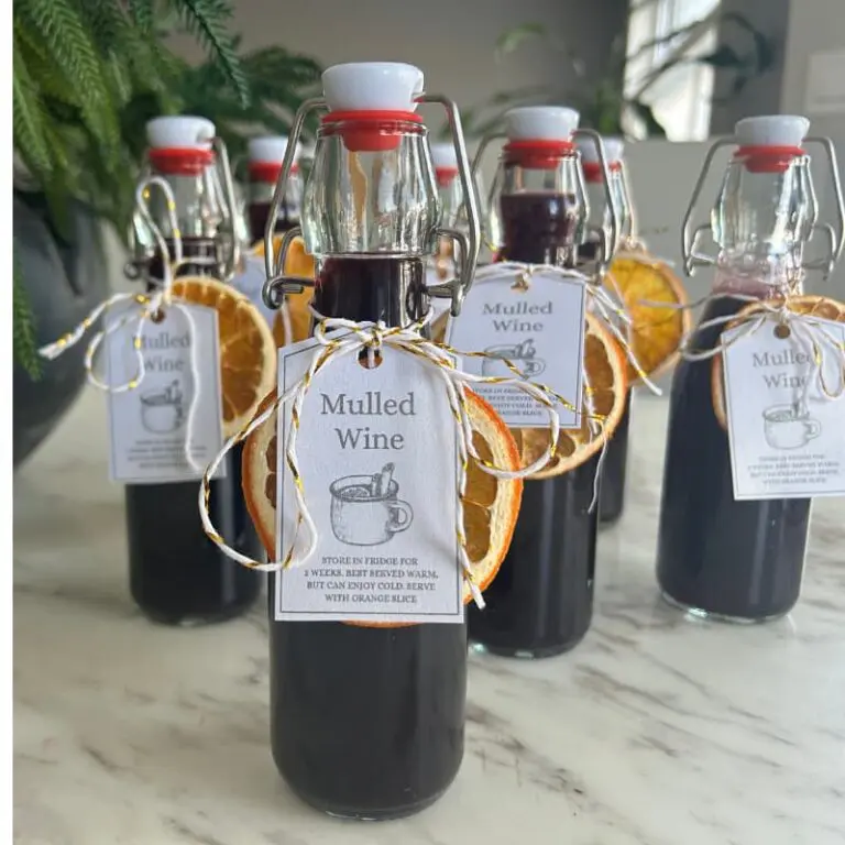 Mulled wine simmering on the stove with orange slices and whole spices