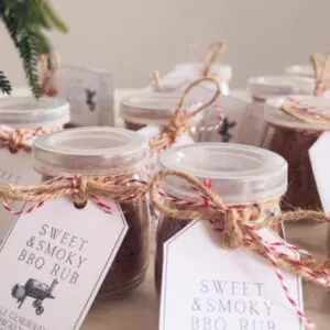 Small glass jars filled with homemade BBQ spice rub with printable gift labels attached