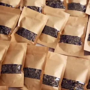 Small gift bags filled with homemade sleepytime tea blend with printable gift labels attached