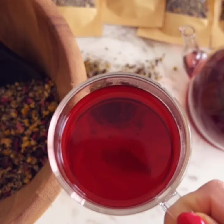 Mixing sleepytime tea blend herbs in a glass bowl