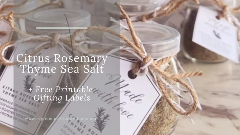 Homemade citrus rosemary thyme sea salt in small glass jars with festive ribbon and printable gift tags, ready for holiday gifting