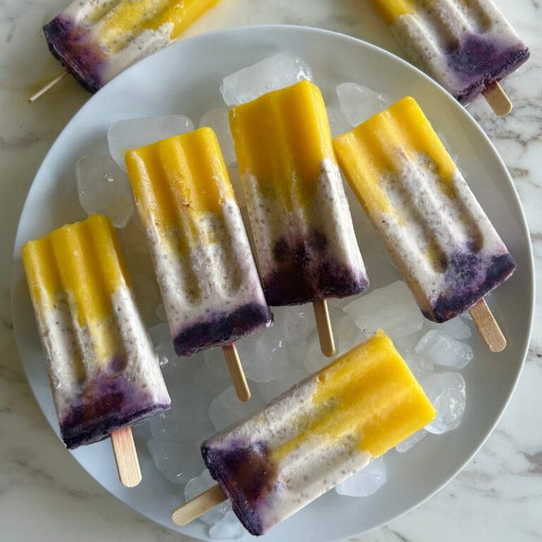Colorful layered hormone support popsicles with mango, coconut chia, and blackberry layers for women over 35 hot flash relief"