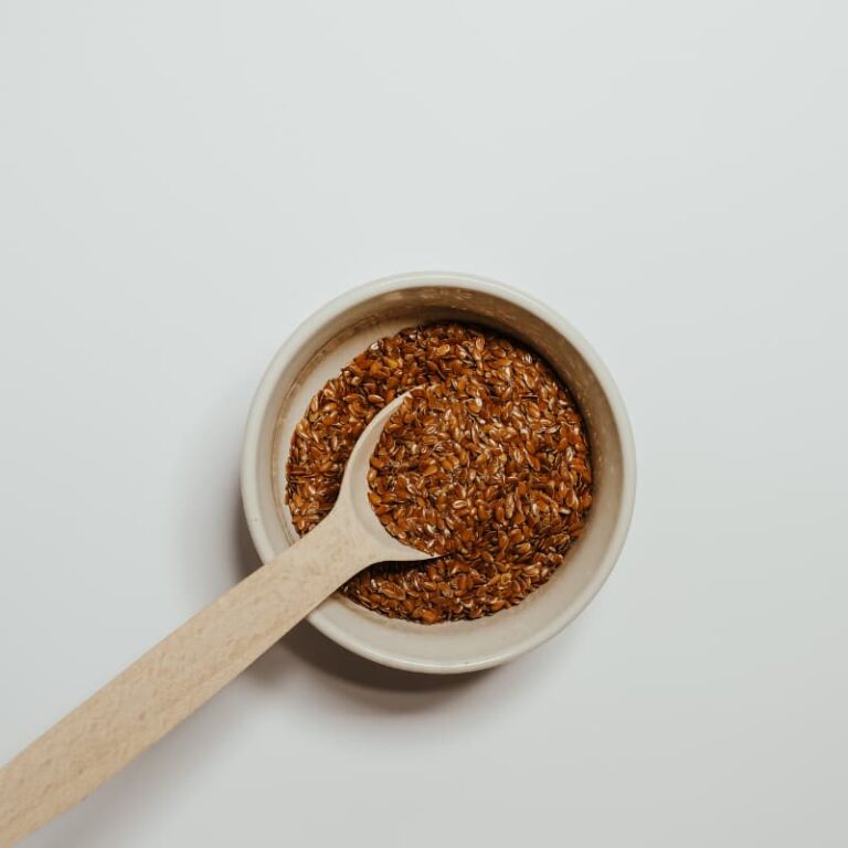 Mixing bowl with mashed banana, eggs, and dry ingredients for chia oatmeal cups