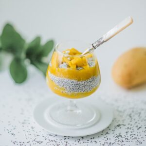 Mixing Greek yogurt with mango and chia seeds