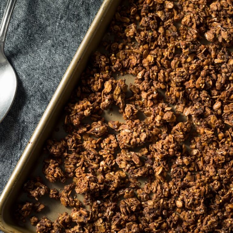 Golden brown protein chia granola baking on sheet pan, homemade healthy breakfast for perimenopause nutrition