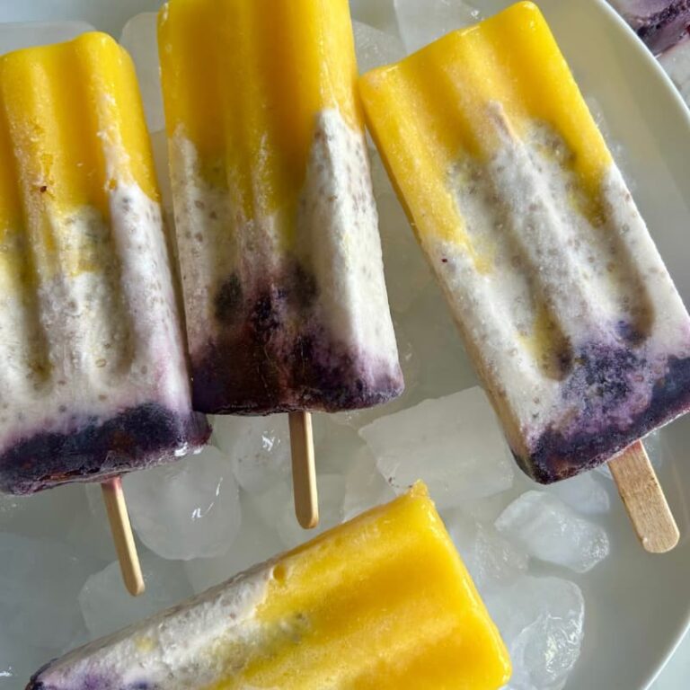hree distinct popsicle layers showing mango collagen top, coconut chia middle, and blackberry bottom for hormone support"