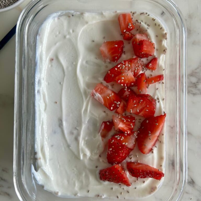 Blending strawberries and protein powder in high-speed blender for chia pudding recipe that supports women's hormone health