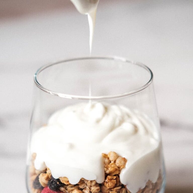 "Nostalgic PB&J inspired power bowl showing layers of yogurt, power butter, strawberry chia jam, and cookie granola for perimenopause nutrition"