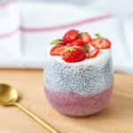 Two servings of vanilla protein strawberry chia pudding in bowls with yogurt topping, showing gel-like consistency perfect for hormone support
