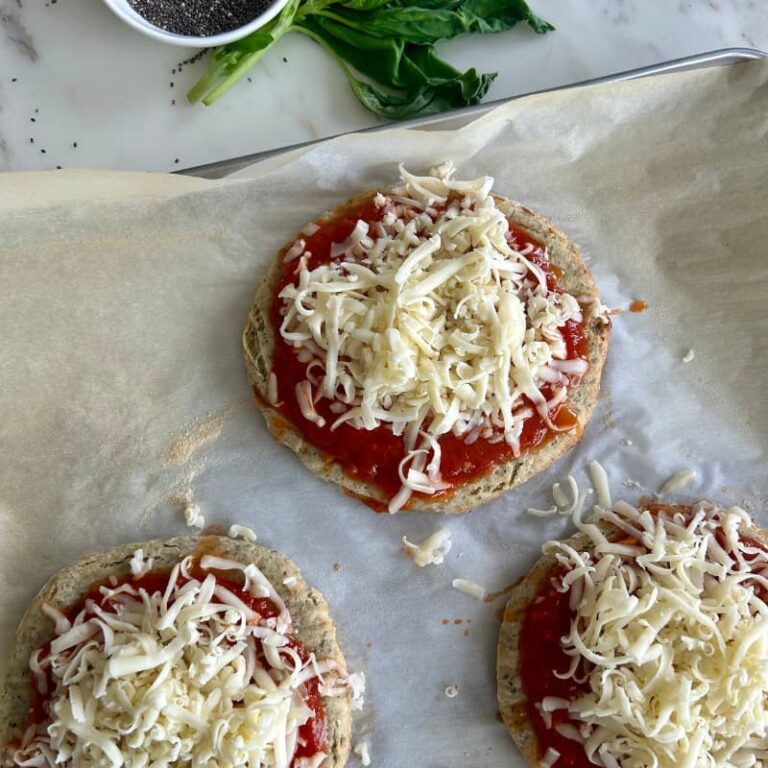 hredded mozzarella cheese evenly distributed over marinara sauce on cottage cheese pizza crust before final baking