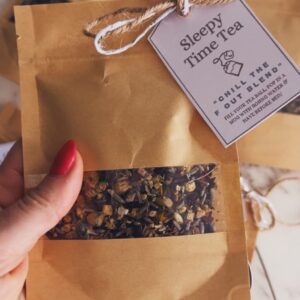 Small gift bags filled with homemade sleepytime tea blend with printable gift labels attached