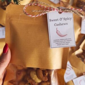 Golden roasted sweet and spicy cashews with fresh rosemary in small gift bags with printable labels attached