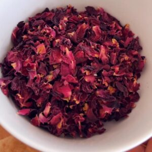 Mixing sleepytime tea blend herbs in a glass bowl