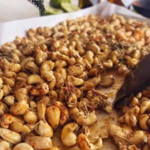 Golden roasted sweet and spicy cashews with fresh rosemary in small gift bags with printable labels attached